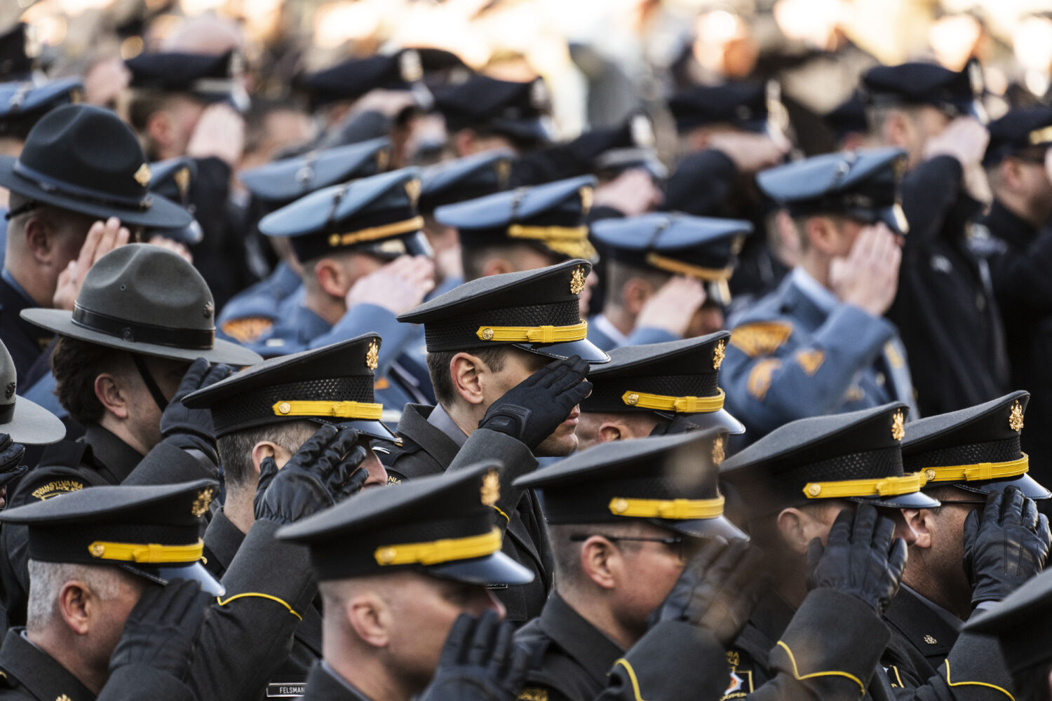 FILE - Law enforcement officers gather as an honor guard carries the casket containing the remains ...