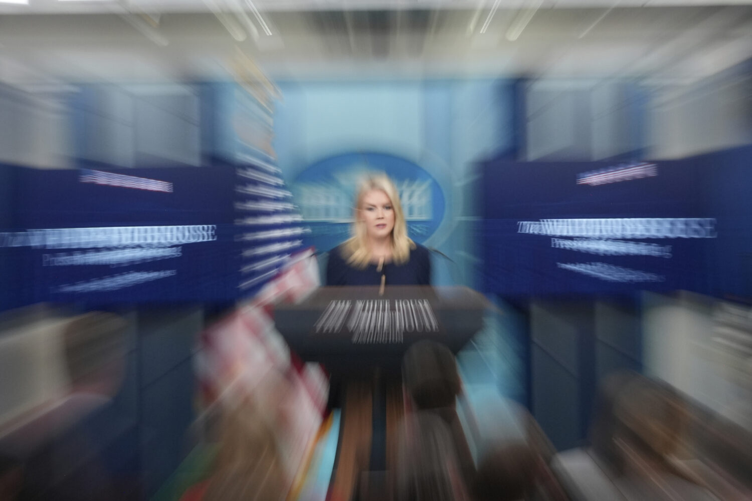 In this long exposure zoom lens effect, White House press secretary Karoline Leavitt speaks with re...