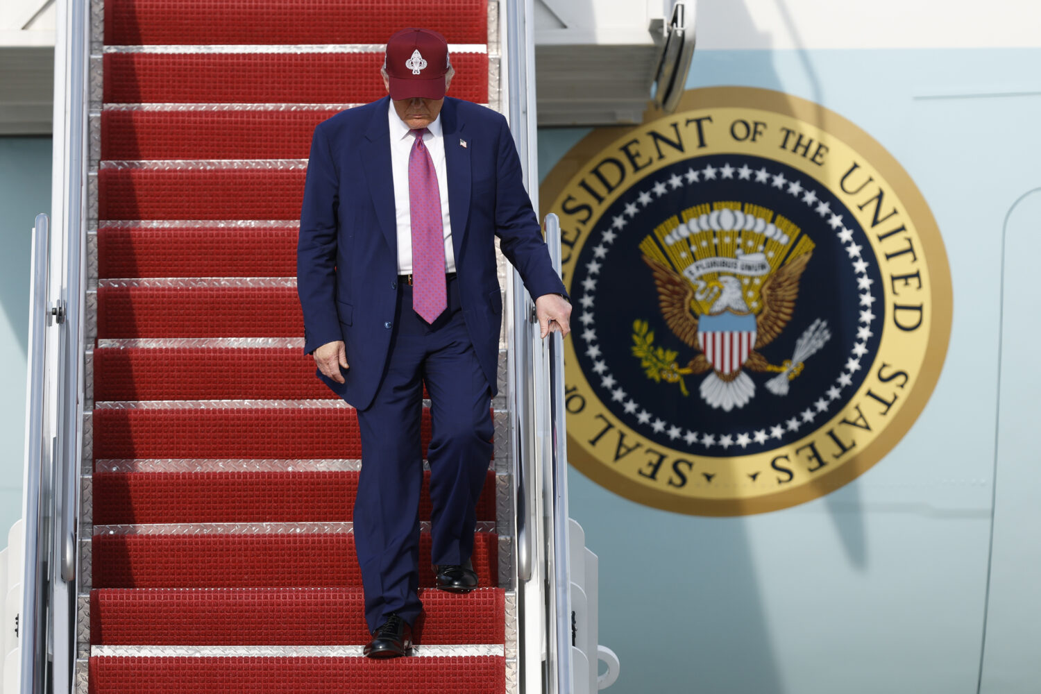 President Donald Trump walks down the stairs of Air Force One upon his arrival at Joint Base Andrew...
