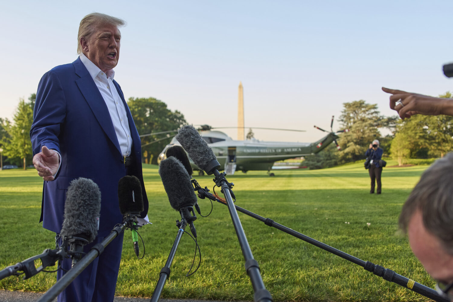 President Donald Trump speaks with reporters before boarding Marine One on the South Lawn of the Wh...