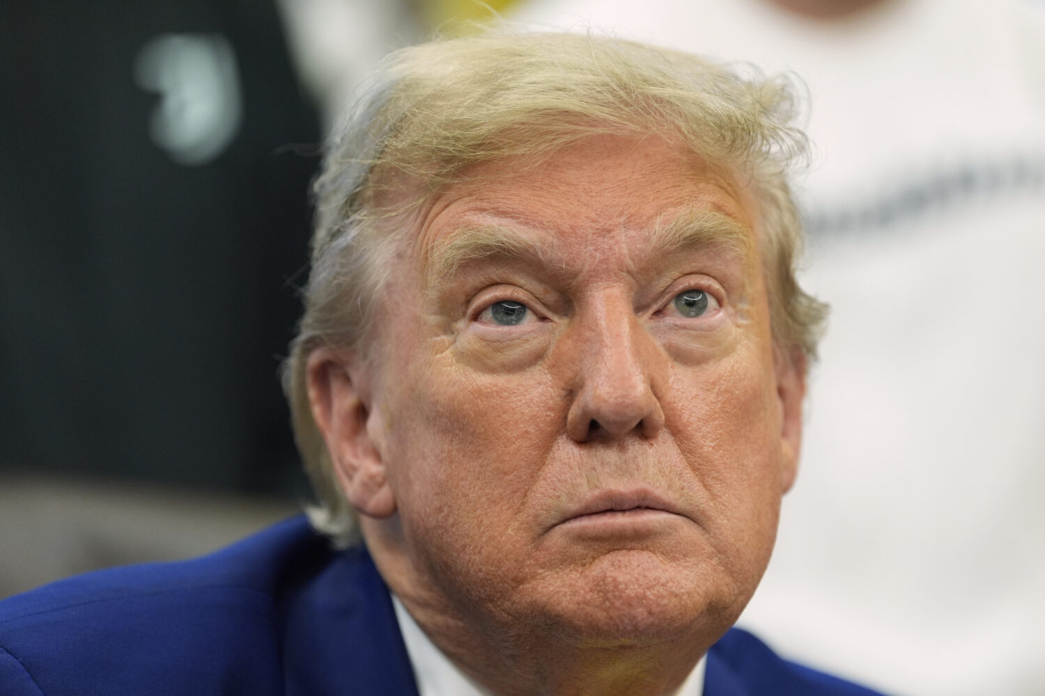 President Donald Trump talks with reporters as he meets with members of the Juventus soccer club in...