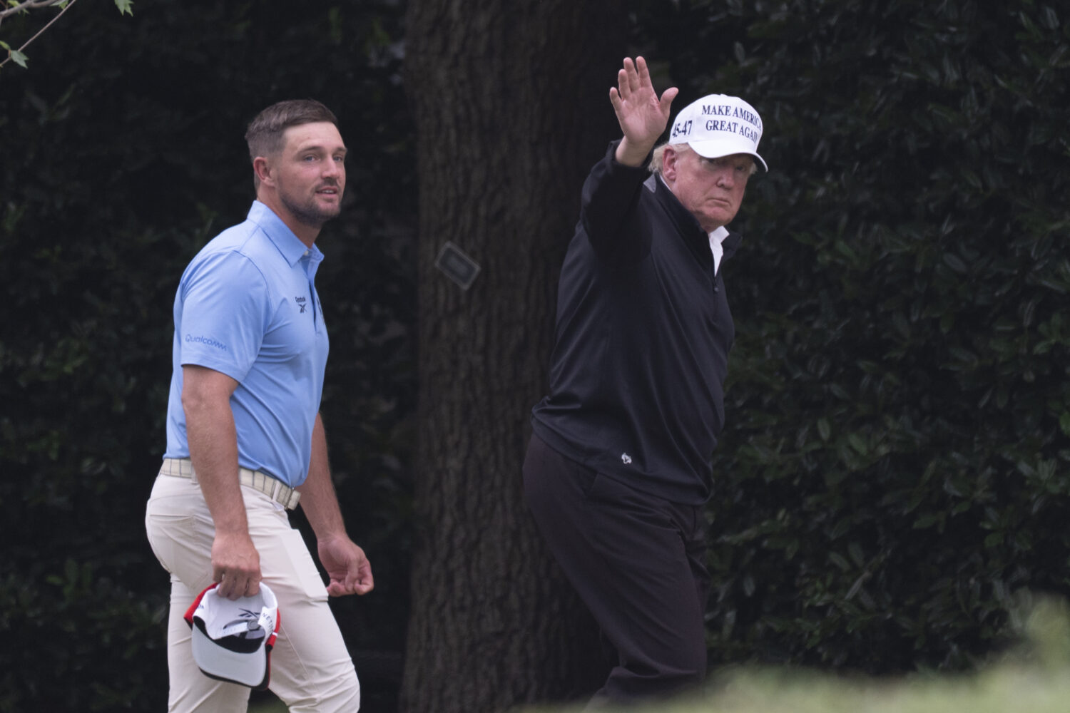 President Donald Trump, right, walks toward the Oval Office as he returns to the White House with B...