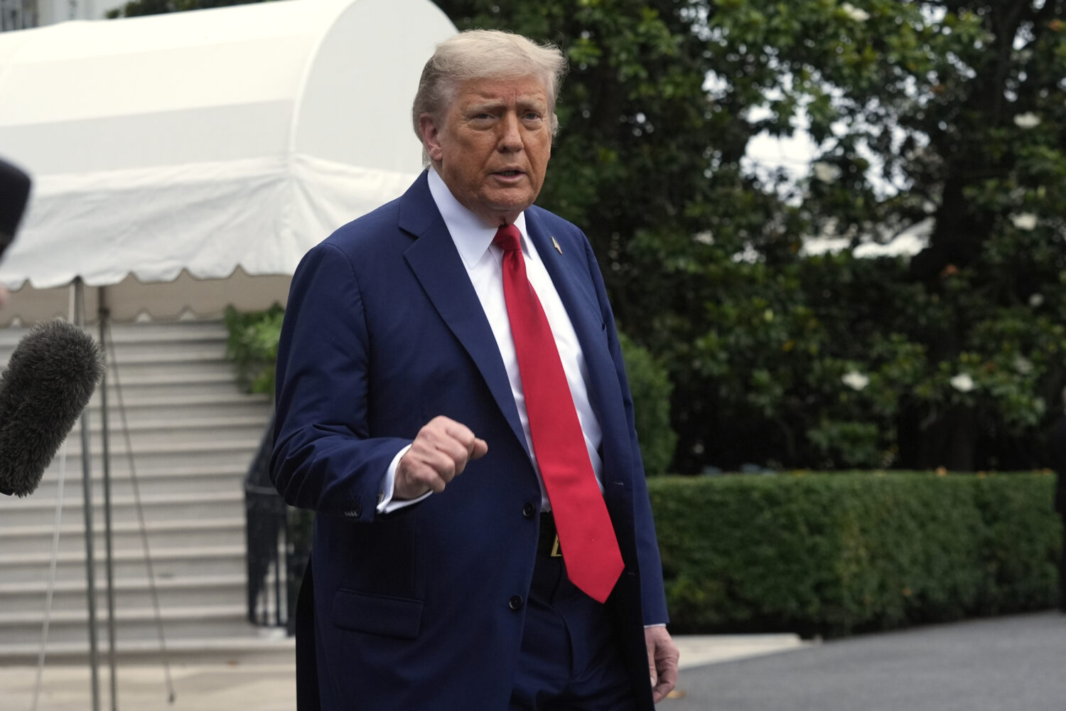 President Donald Trump walks to board Marine One after speakiing with reporters to depart the White...