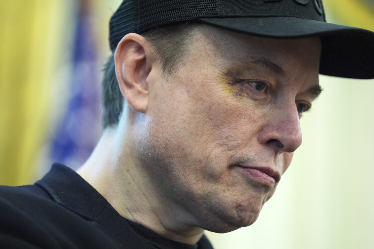 Elon Musk listens as President Donald Trump speaks during a news conference in the Oval Office of t...
