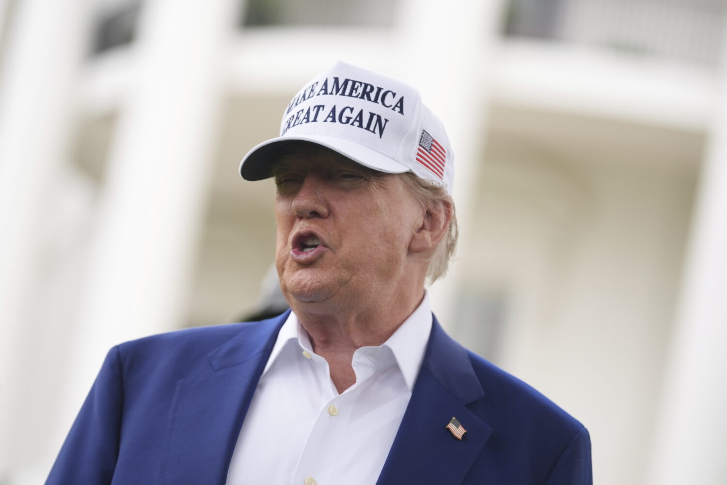 President Donald Trump speaks as a flag pole is installed on the South Lawn of the White House, Wed...