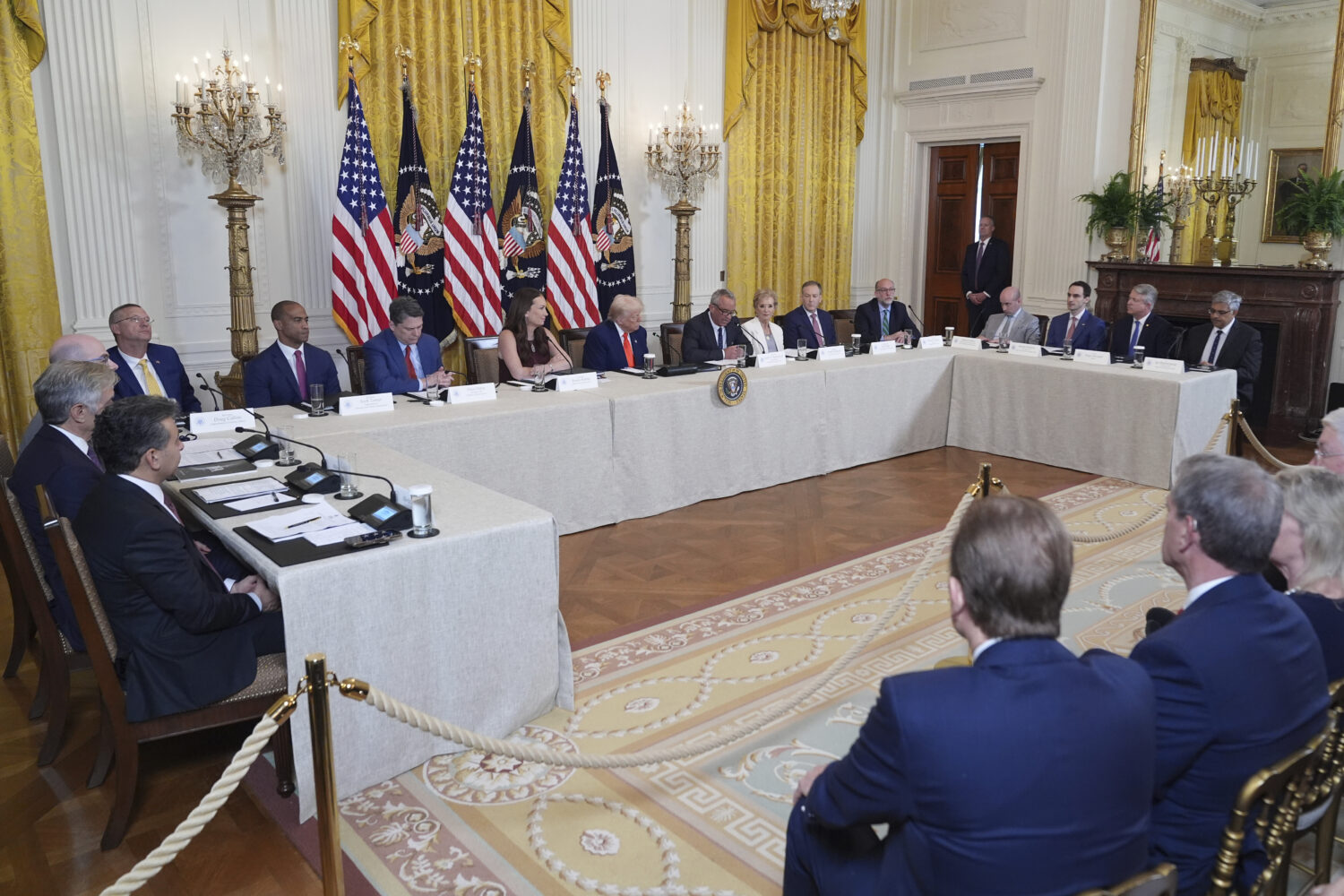 President Donald Trump, seated and center, listens during a Make America Healthy Again (MAHA) Commi...