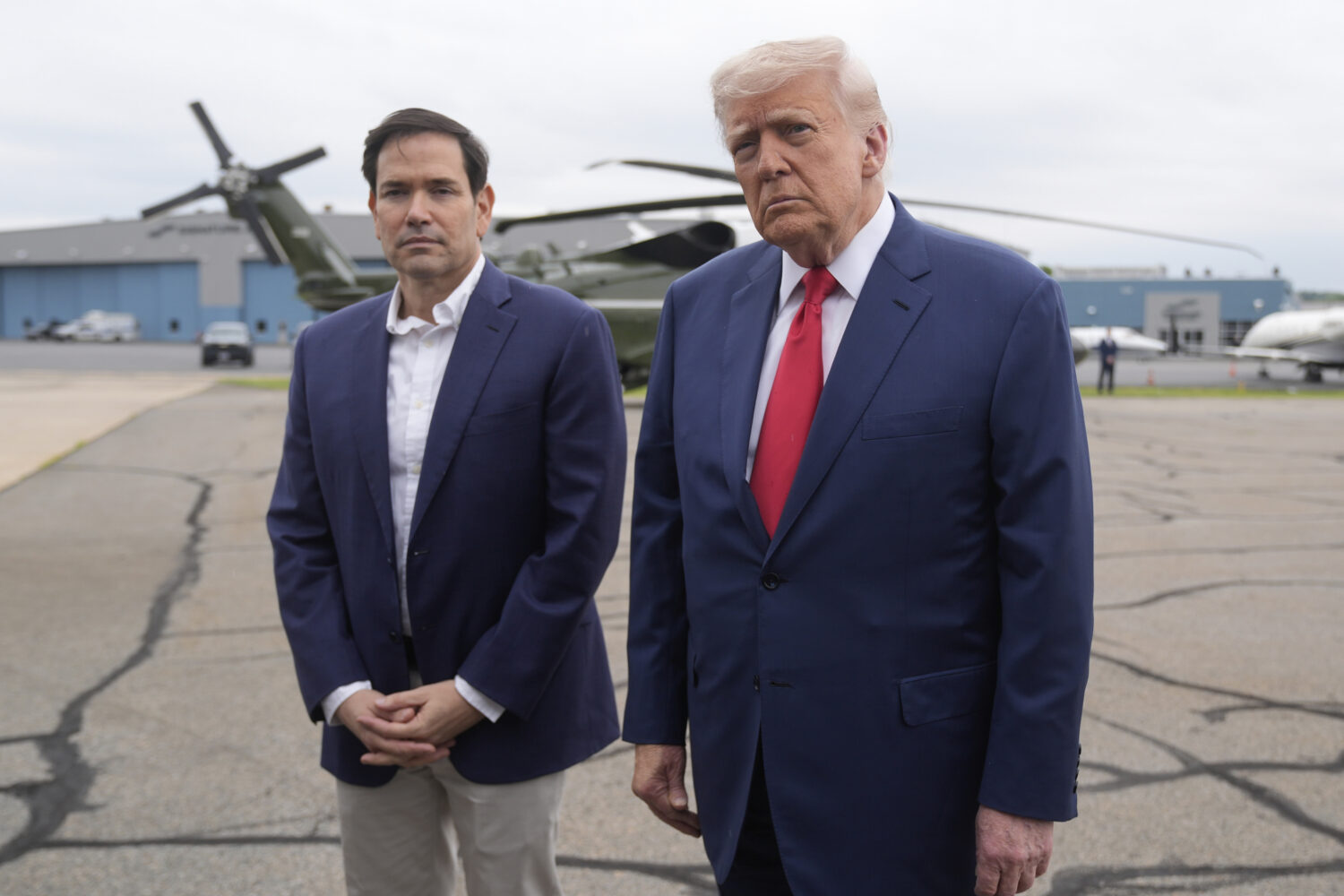 President Donald Trump, right, listens to a question from a reporter alongside Secretary of State M...