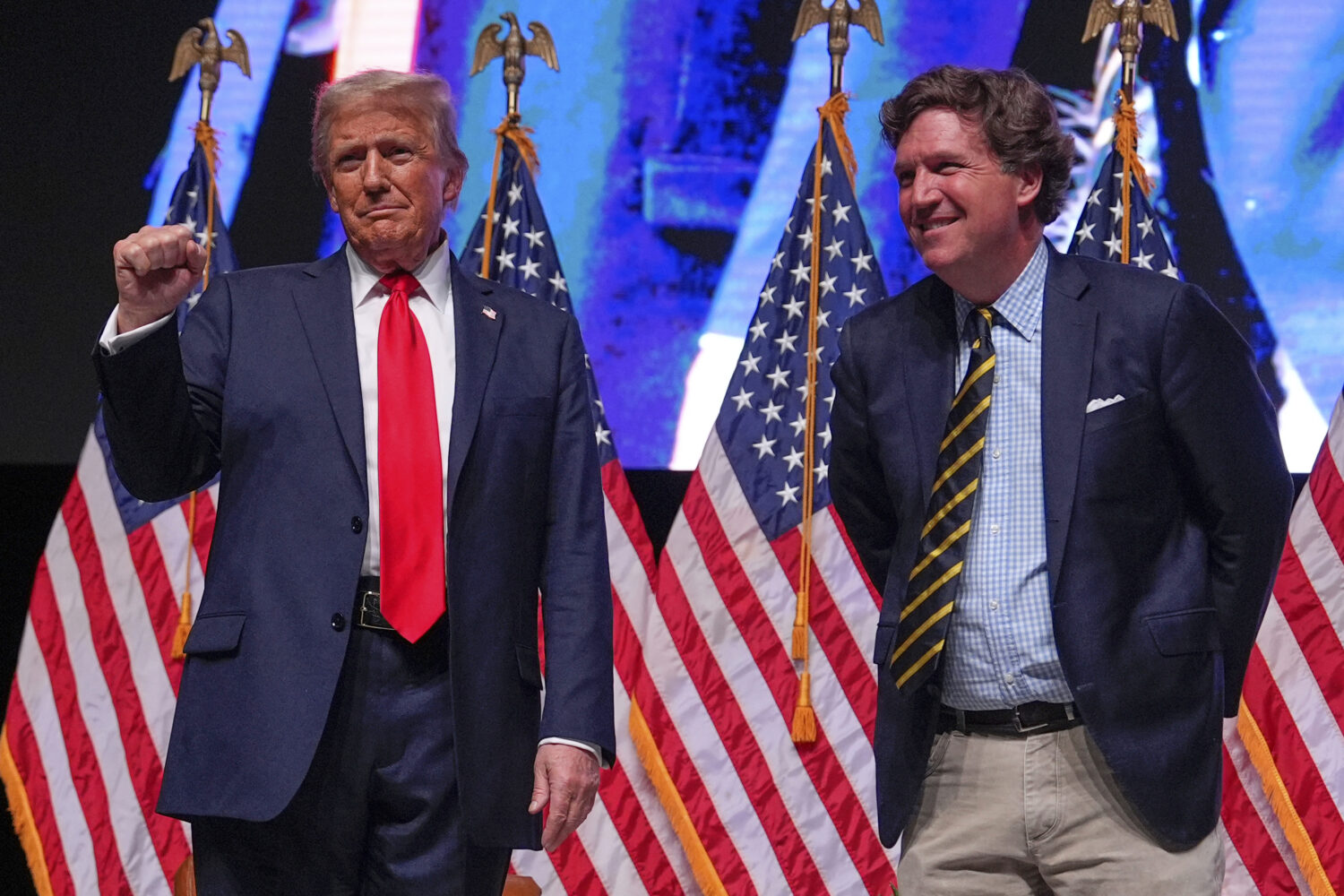 FILE - Republican presidential nominee former President Donald Trump speaks with Tucker Carlson dur...