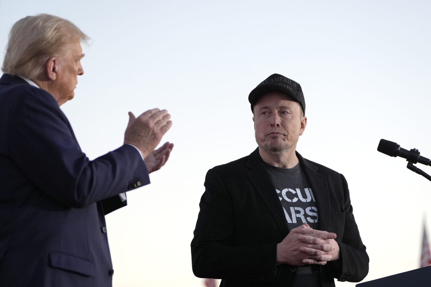 FILE - Republican presidential nominee former President Donald Trump, left, claps as Tesla and Spac...
