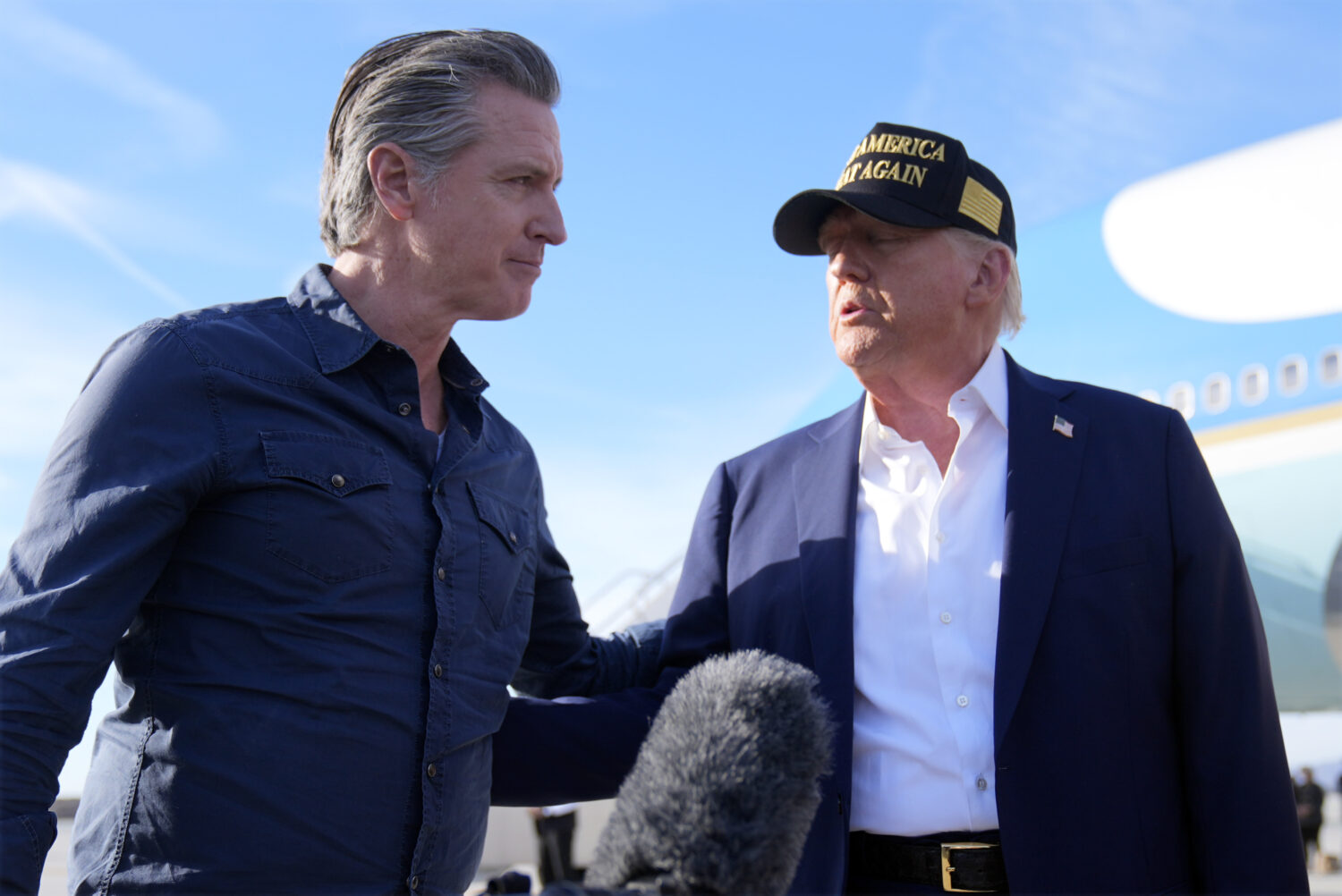 FILE - President Donald Trump talks with California Gov. Gavin Newsom after arriving on Air Force O...