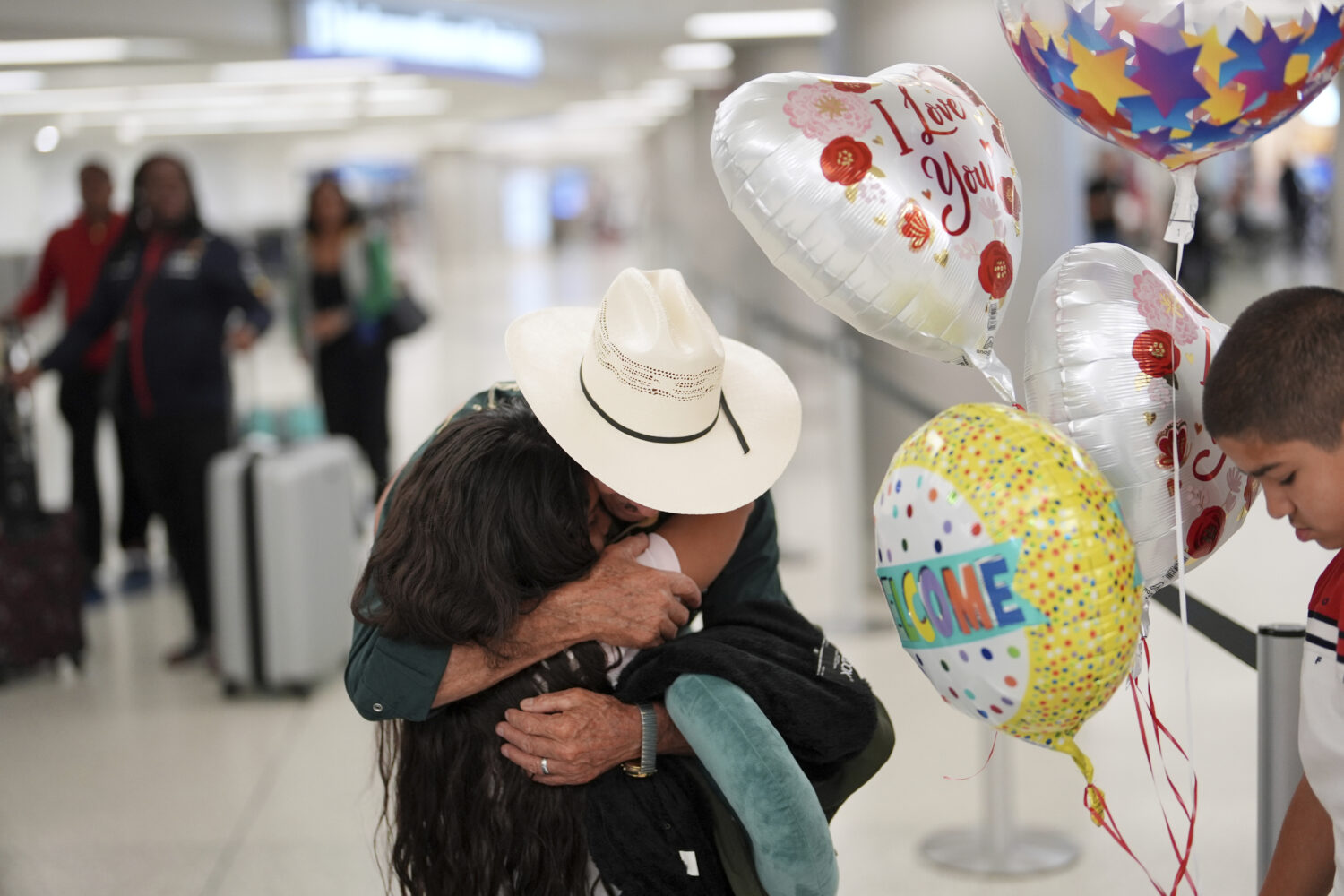 Alfredo de Jesus Reynoso Gonzalez, 73, center, greets two grandchildren he is meeting in person for...