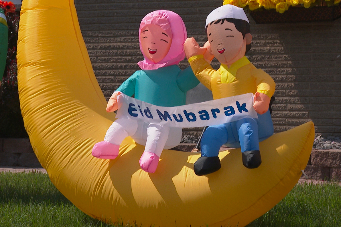In this image made from video, a decoration celebrating the Islamic holiday of Eid al-Adha is set u...