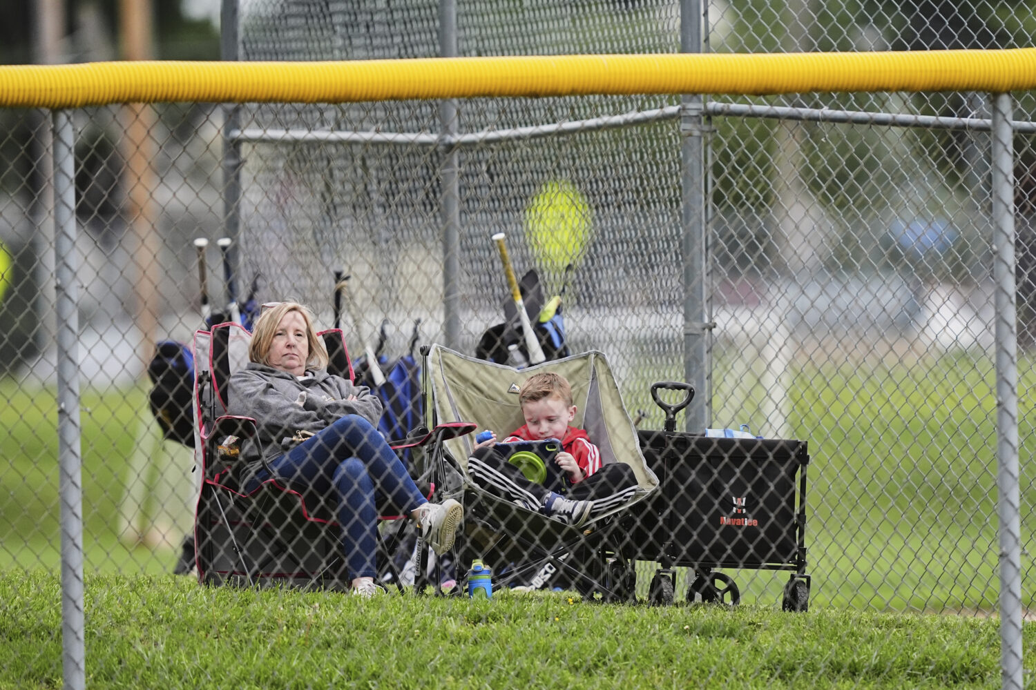 Karli Casamento, watches of her 15-year-old son, Jax's youth baseball game with her son seven-year-...