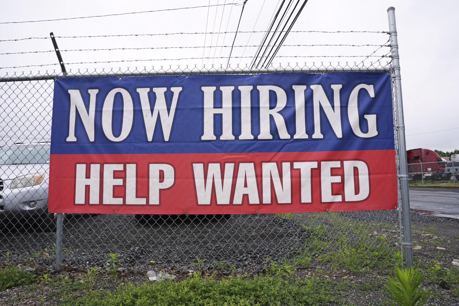 A now hiring and help wanted sign is posted in Morrisville, Pa., Monday, June 9, 2025. (AP Photo/Ma...
