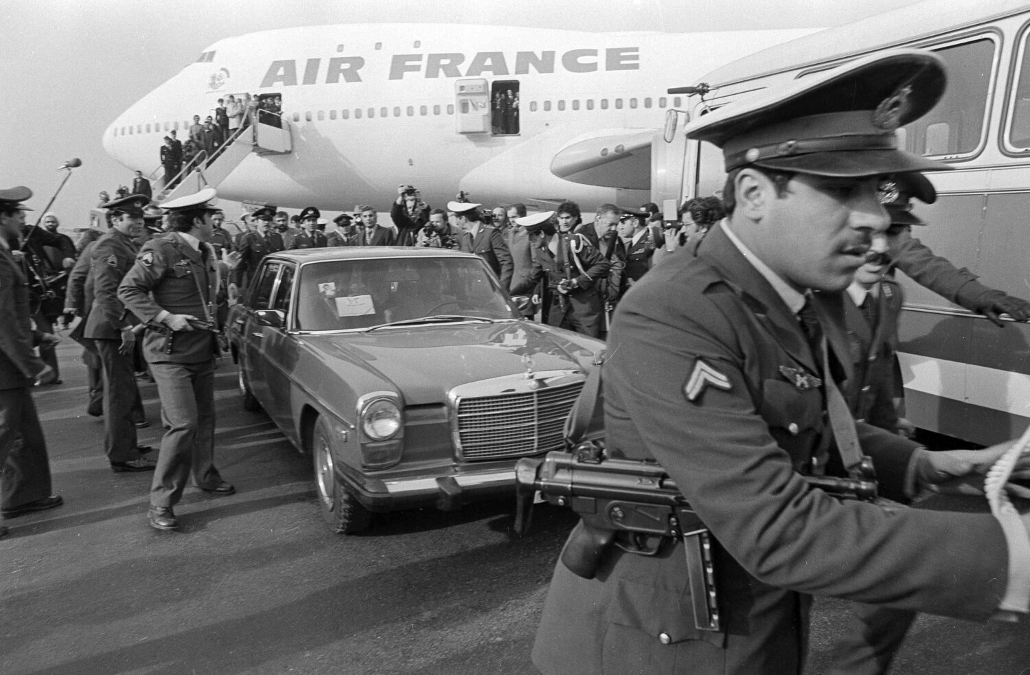 FILE - Ayatollah Ruhollah Khomeini has a heavy escort as he enters car to leave the airport in Tehr...