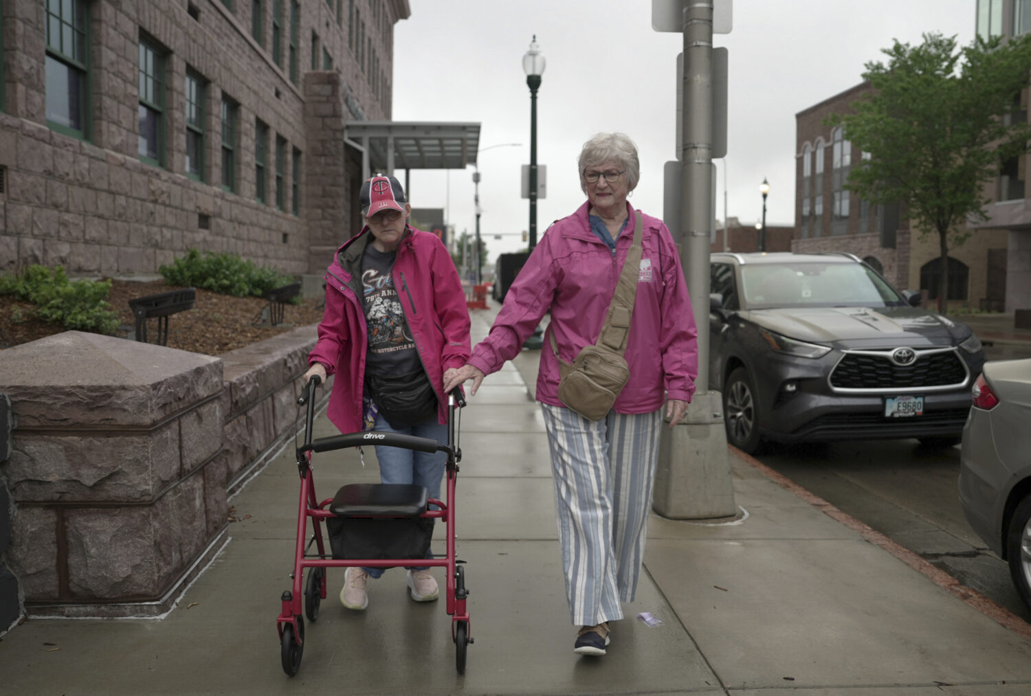 Jacque Farnham, 60, left, walks with her mother, Janith, 80, to the Visual Arts Center at the Washi...