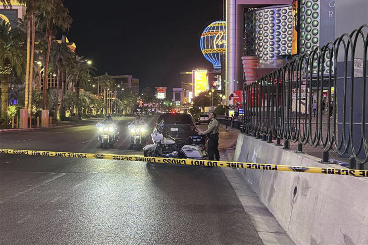 Las Vegas Metropolitan Police officers investigate the scene of a shooting on the Strip that left t...