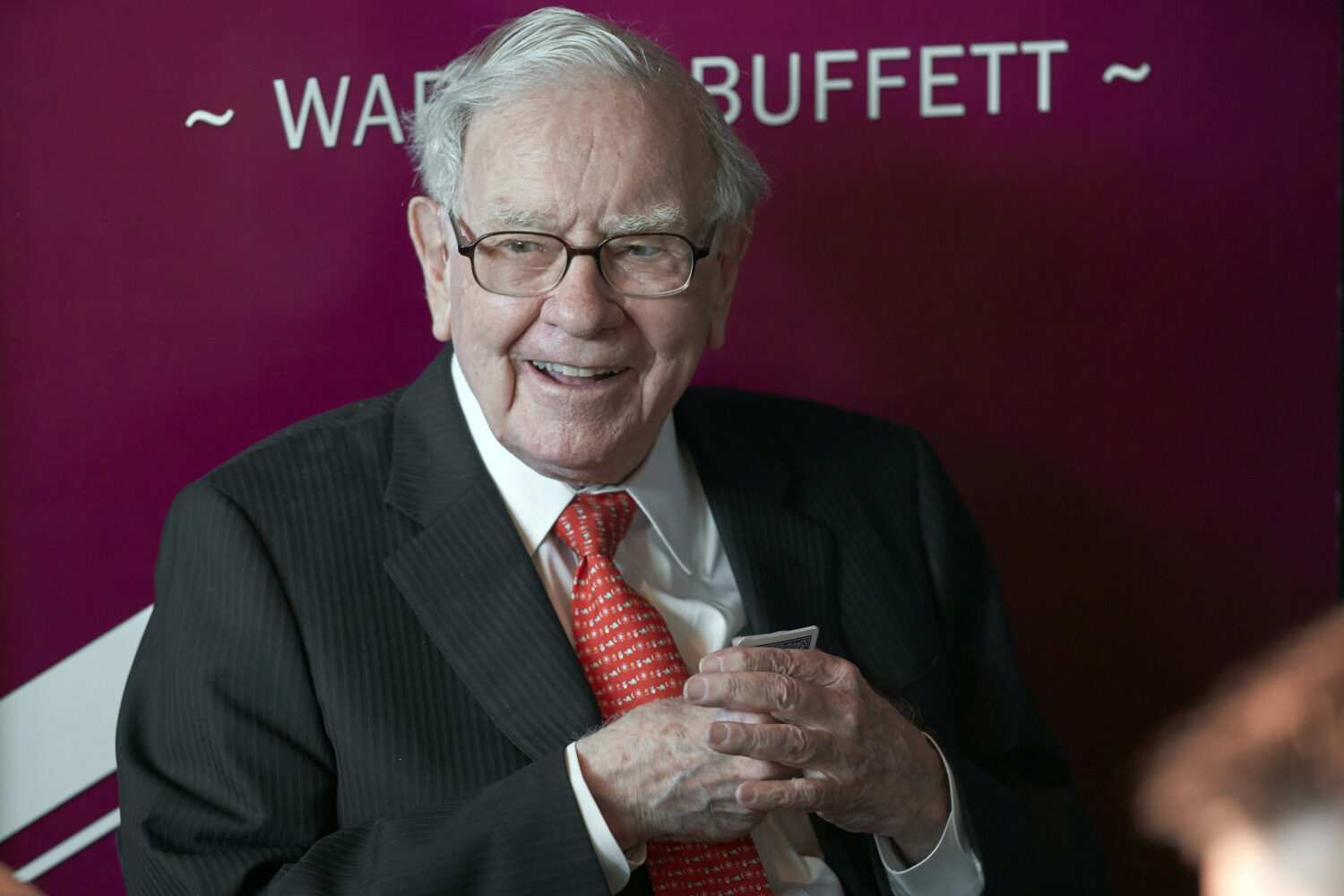 FILE - Warren Buffett, chairman and CEO of Berkshire Hathaway, smiles as he plays bridge following ...