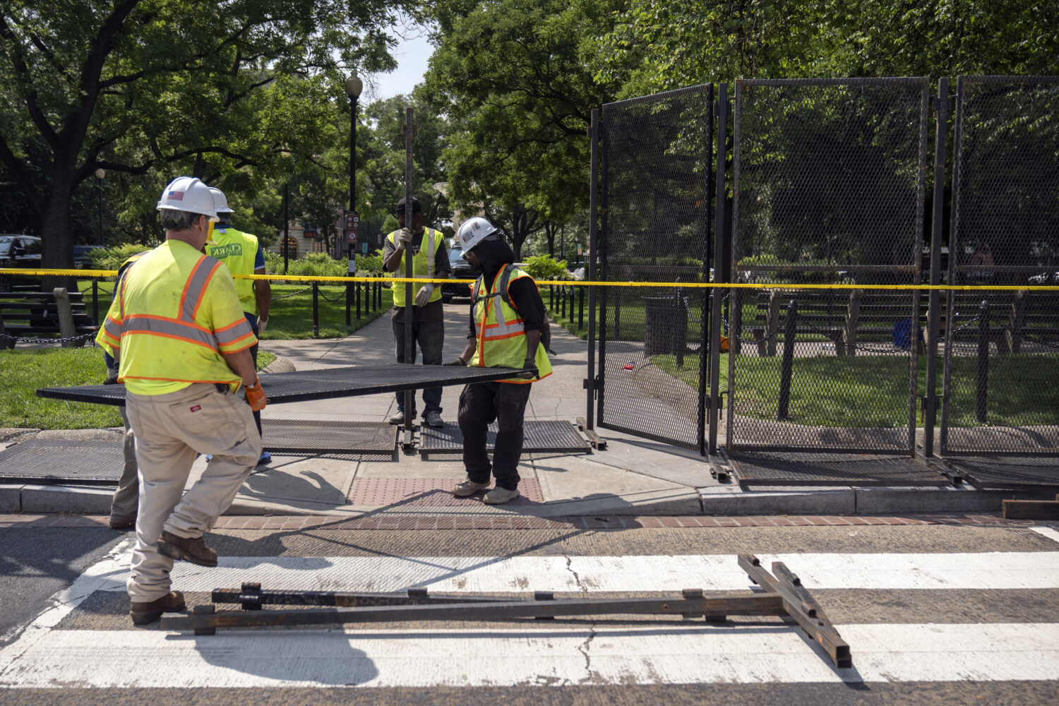 Workers put up fencing around Dupont Circle ahead of the World Pride Parade, Friday, June 6, 2025, ...