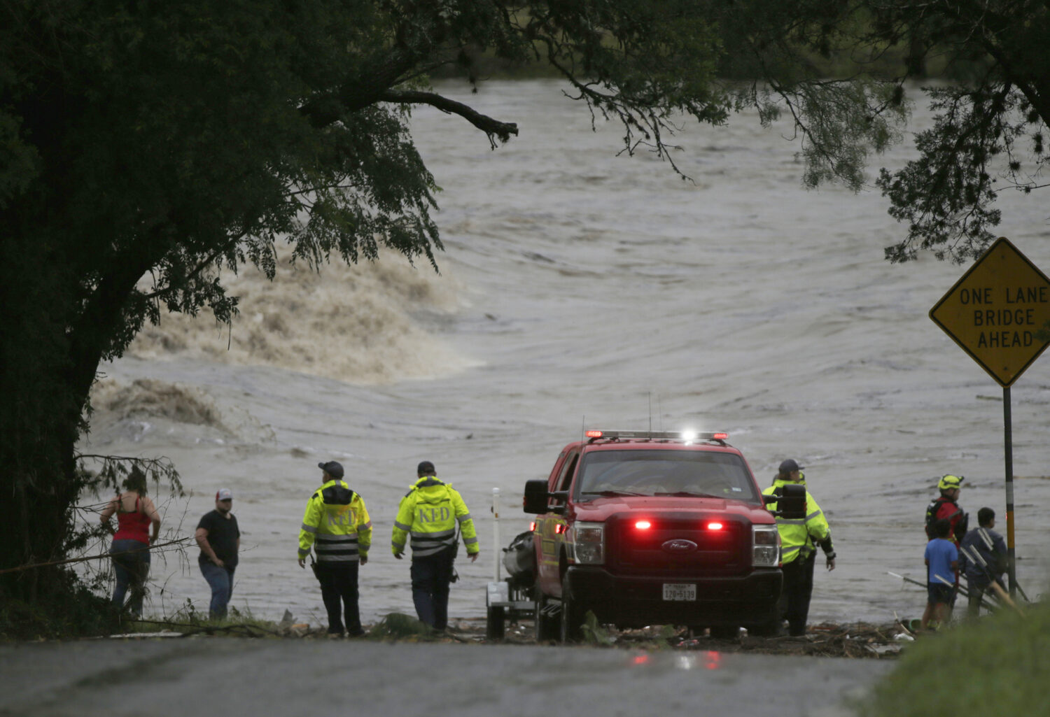 First responders scan the banks of the Guadalupe River for individuals swept away by flooding in In...