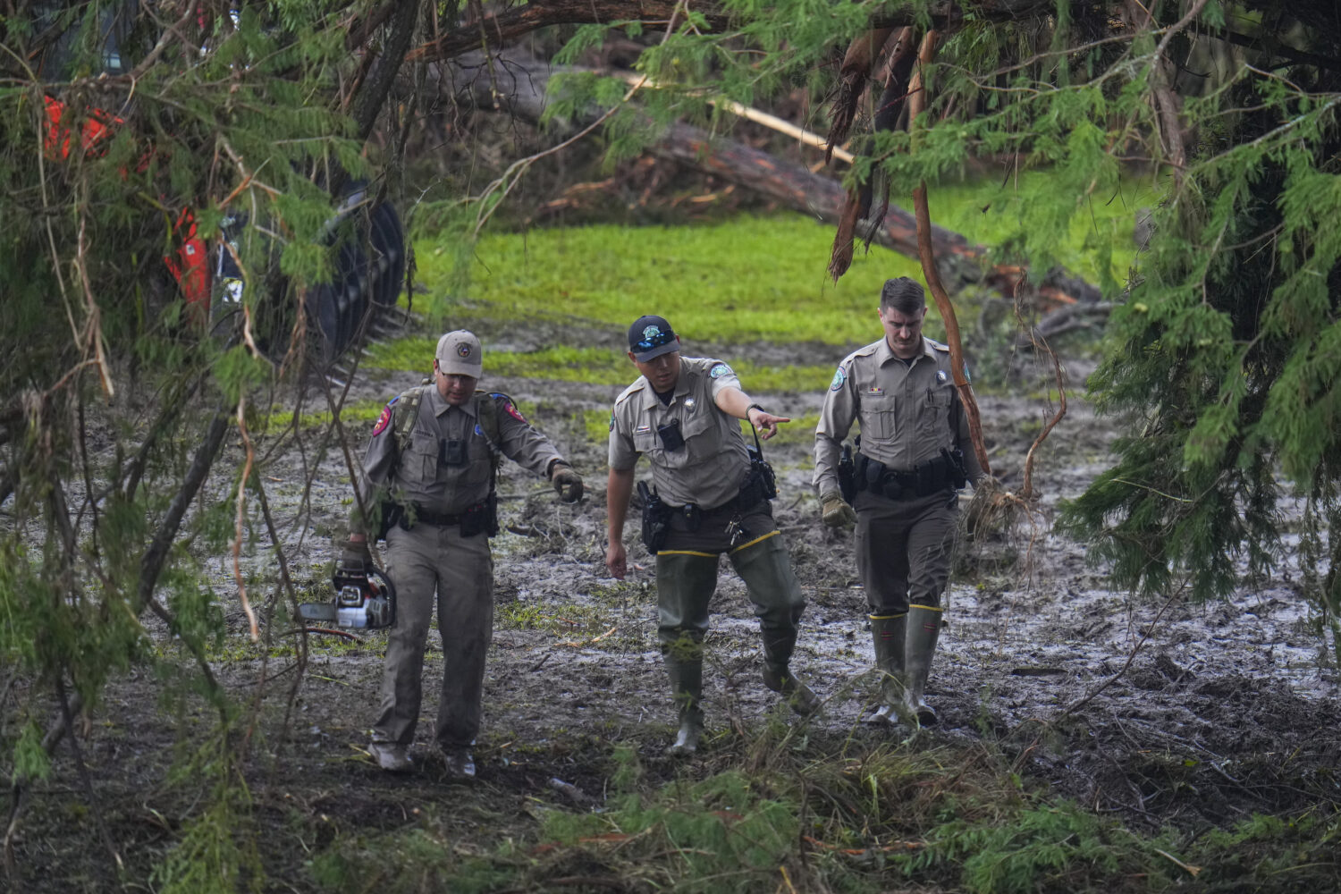 Officials inspect an area at Camp Mystic along the banks of the Guadalupe River after a flash flood...