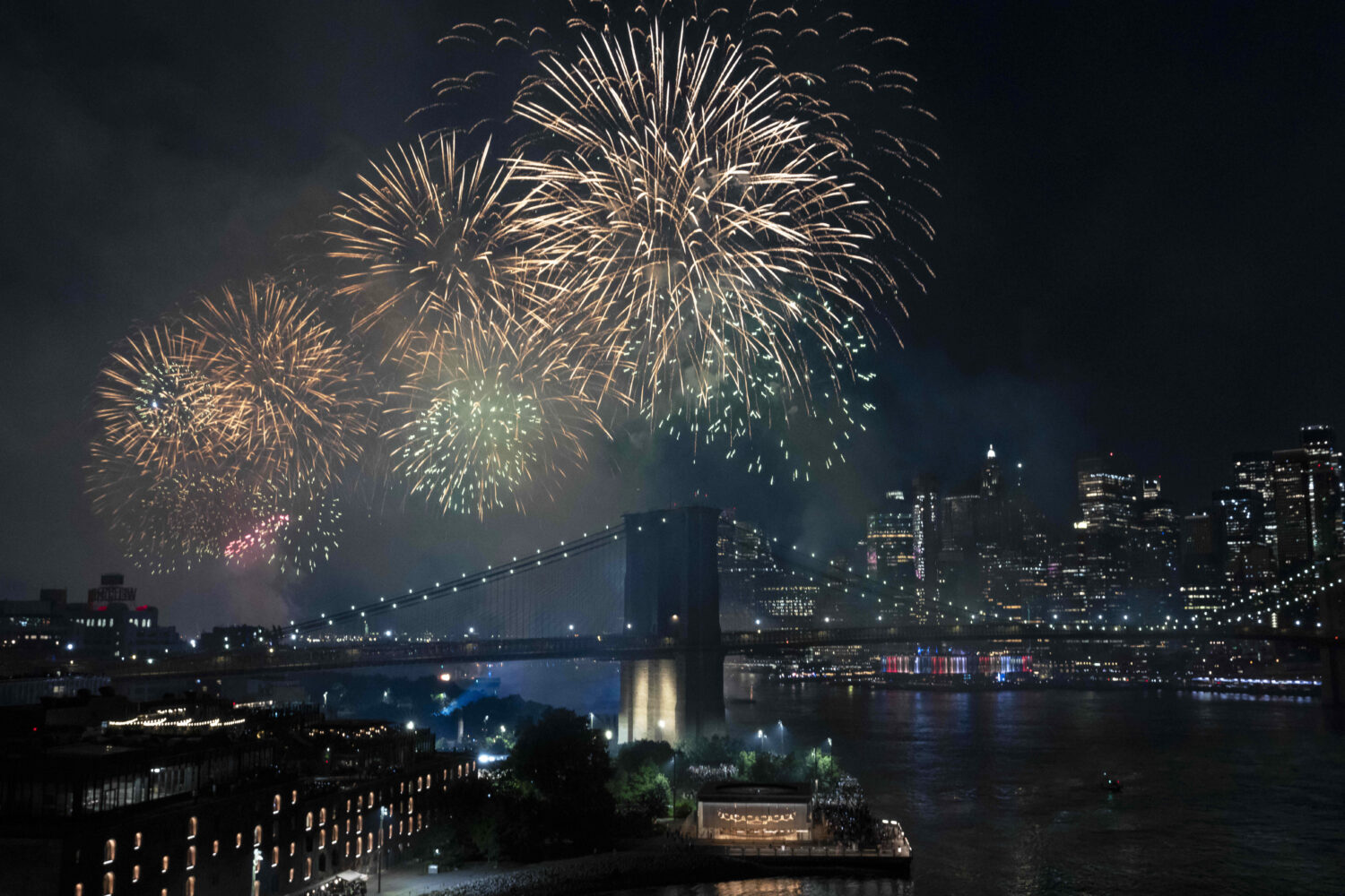 Fireworks light up the sky above the Brooklyn Bridge during the Macy's Fourth of July fireworks sho...