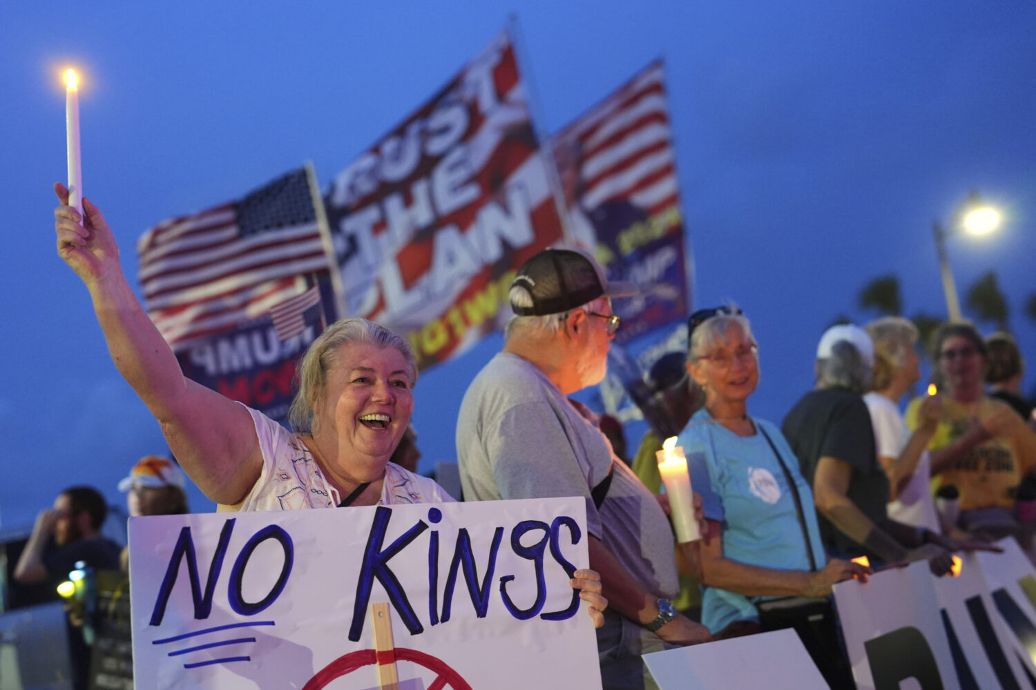 Dee Cahill of Margate, Fla., holds a "No Kings" sign as she participates in a pro-democracy, anti-T...