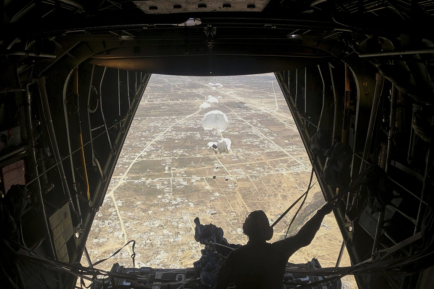 Humanitarian aid destined for Palestinians is airdropped over the Gaza Strip by a Jordanian Air For...