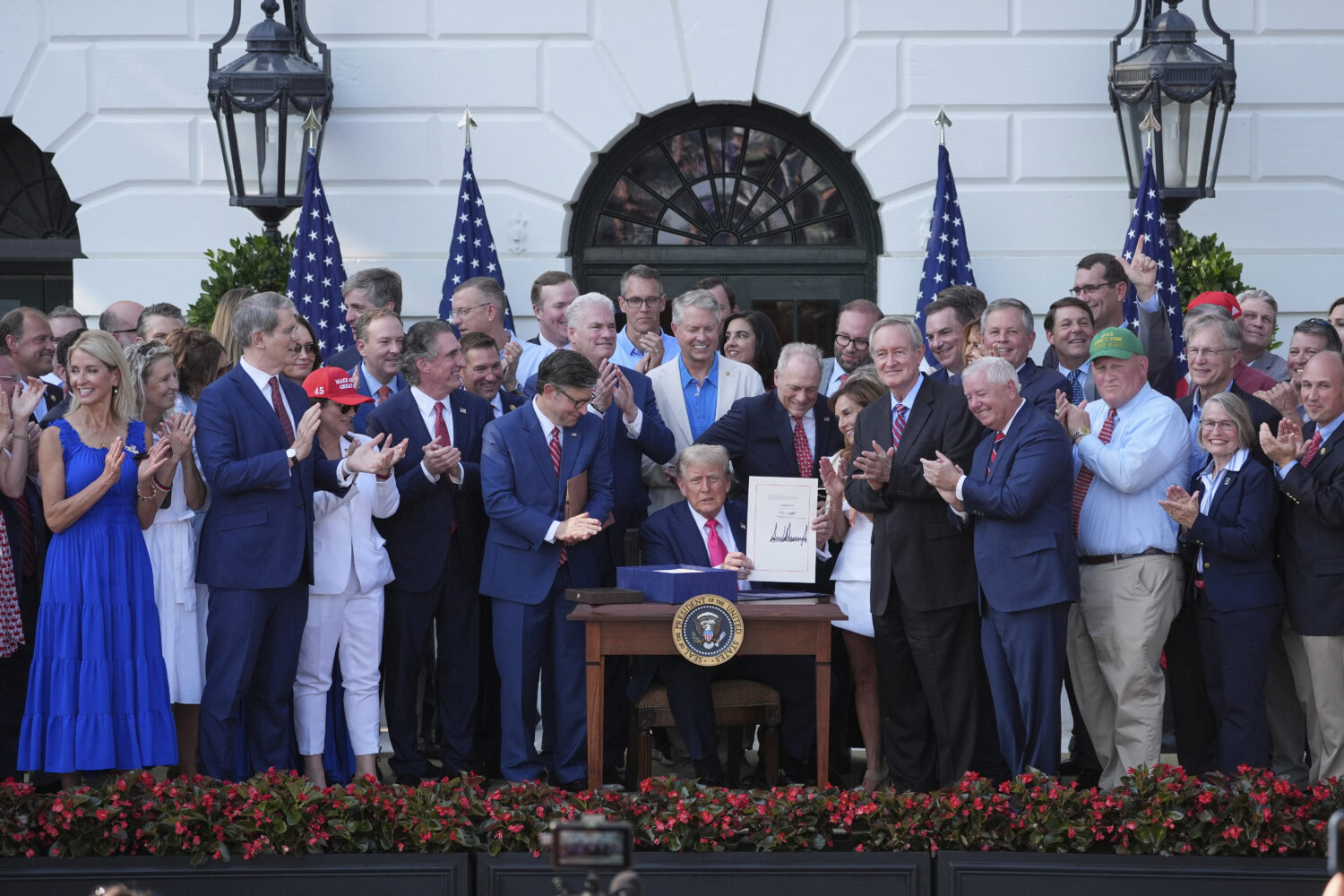 President Donald Trump signs his signature bill of tax breaks and spending cuts at the White House,...