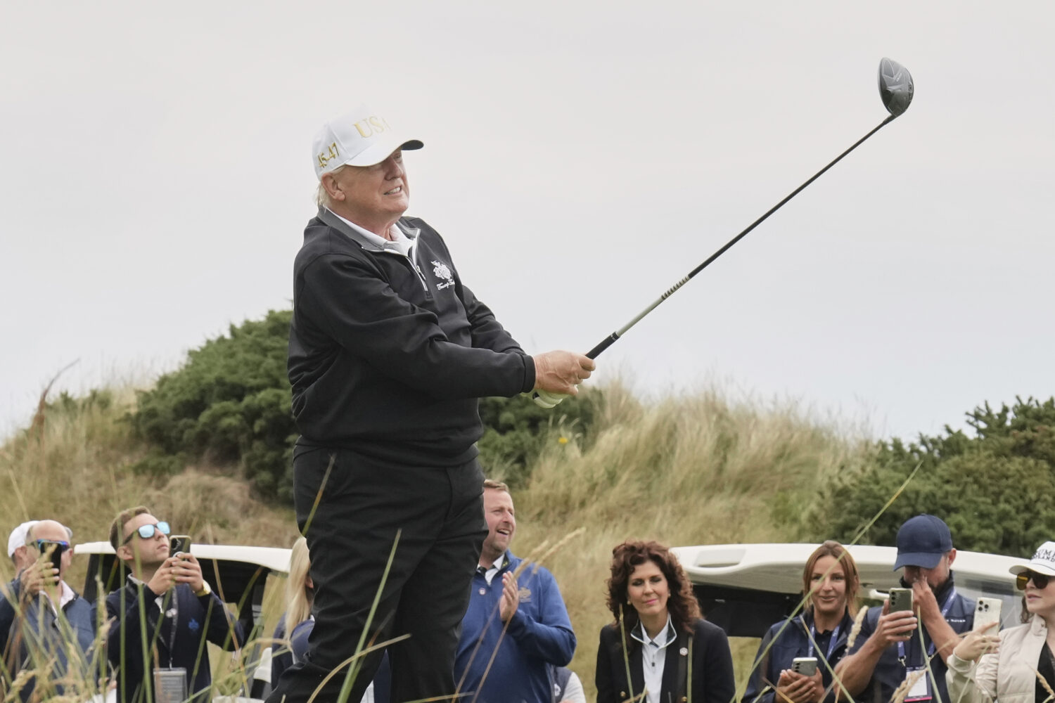 President Donald Trump tees off during the opening ceremony for the Trump International Golf Links ...