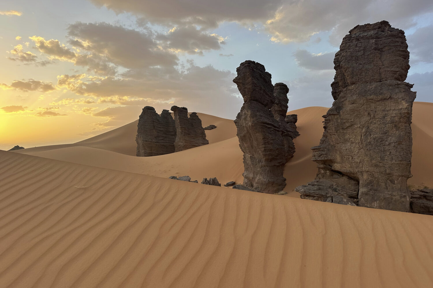 Rock formations stand in the Sahara desert outside the city center of Djanet, a southeastern Algeri...