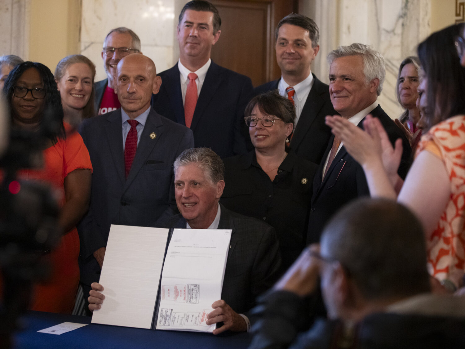 Rhode Island Gov. Dan McKee presents a signed bill that bans the sale of assault-style weapons in t...