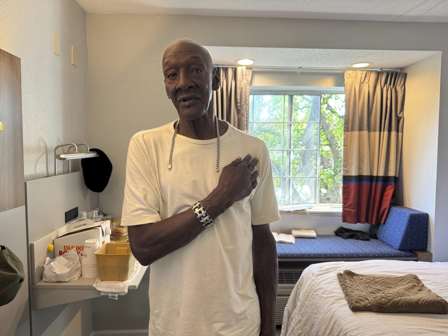 Allen Hall, 71, poses for a photo in his room at a hotel in Atlanta, Wednesday, July 23, 2025, with...