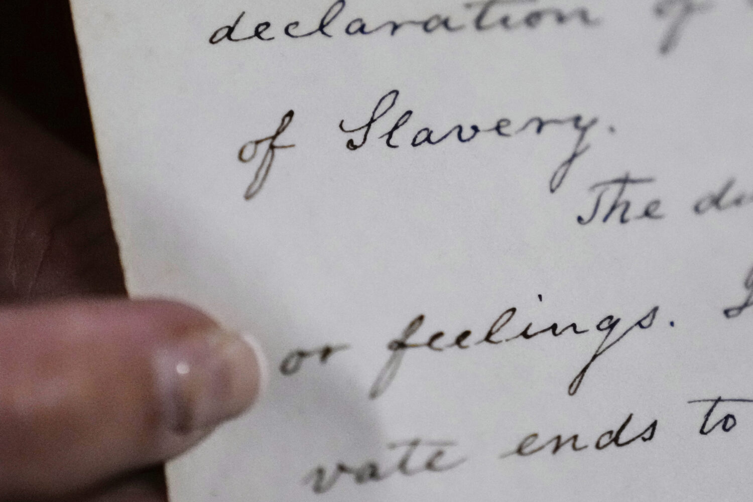 Historian Jennifer Cromack points out the word "Slavery" on a recently found, 178-year-old anti-sla...