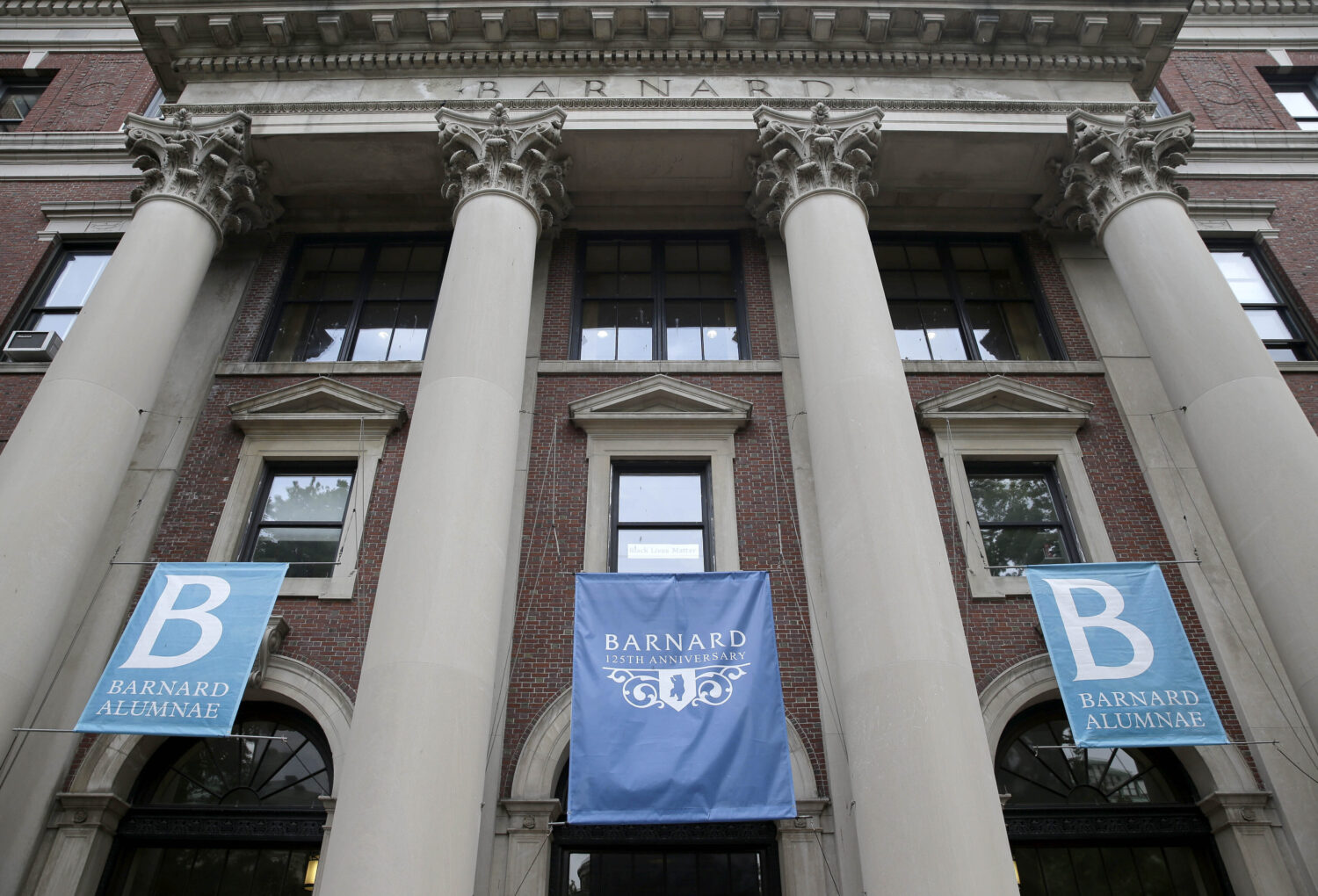 FILE - Banners hang from a building at Barnard College, May 28, 2015, in New York. (AP Photo/Seth W...