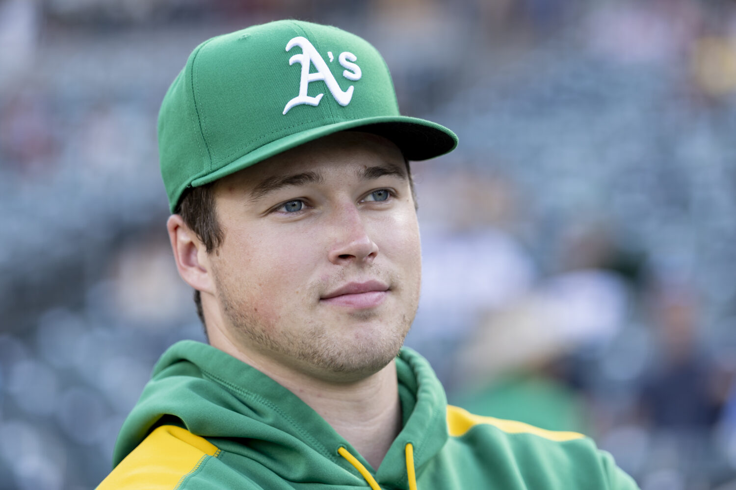 Athletics pitcher Mason Miller looks to the field before a baseball game against the Toronto Blue J...