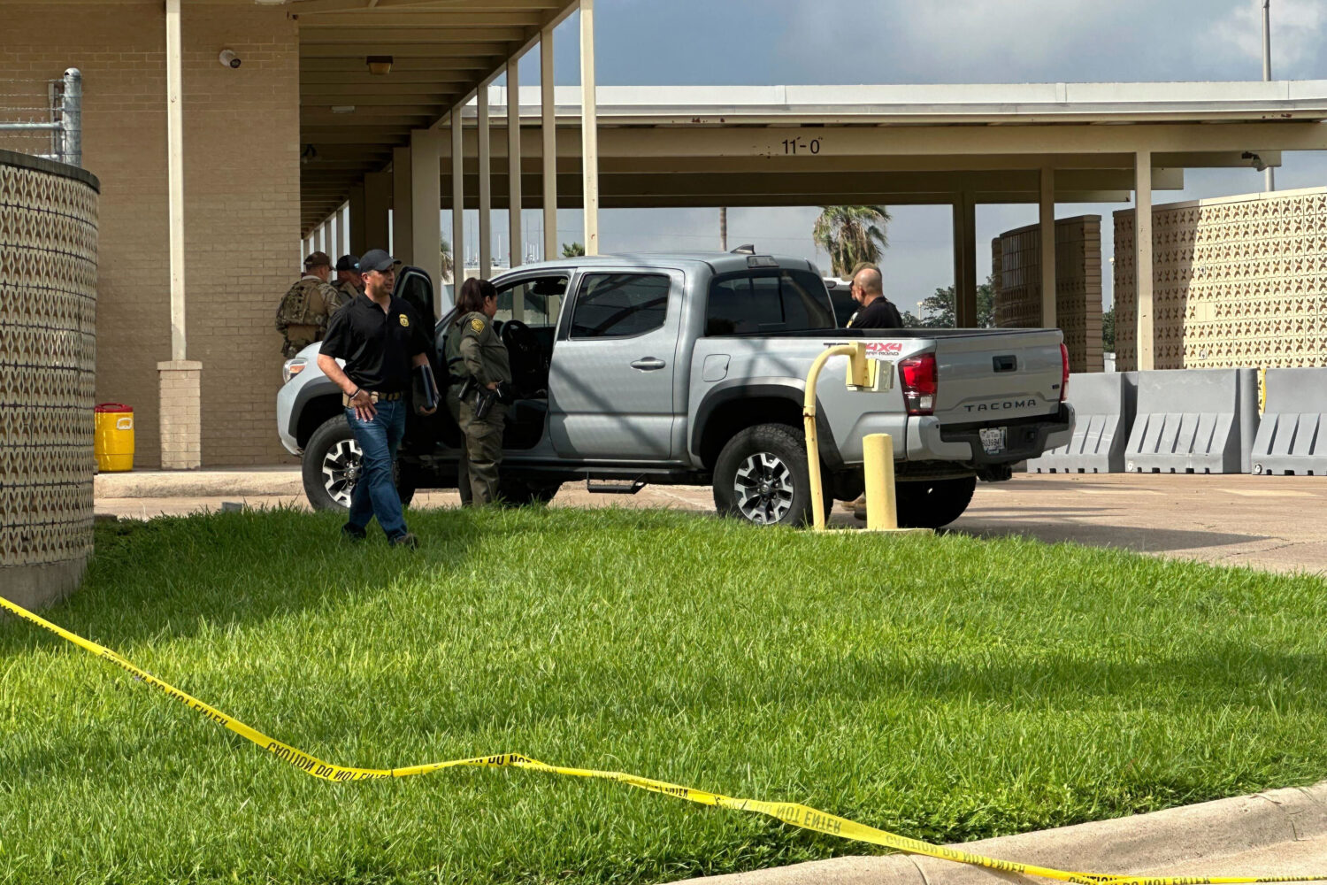 Officials work the scene of a shooting at a Border Patrol facility in McAllen, Texas, Monday, July ...