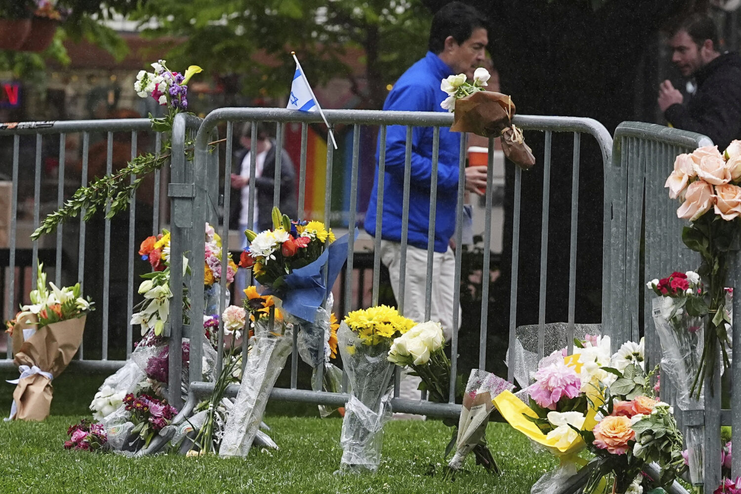FILE - Bouquets of flowers stand along a makeshift memorial for victims of an attack outside of the...