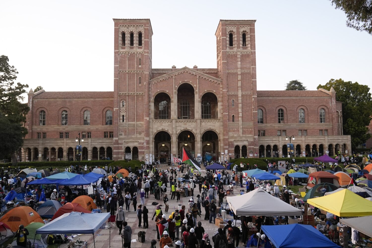 FILE - Demonstrators walk in an encampment on the UCLA campus after clashes between pro-Israel and ...