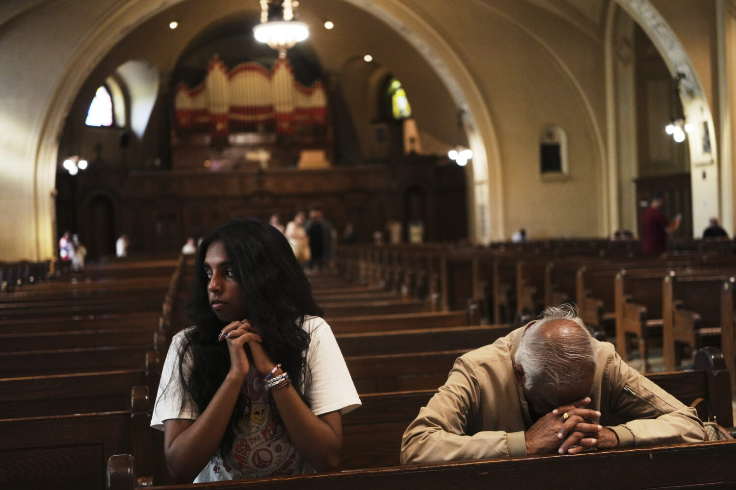 Thurvi Valli and her grandfather, Sitham Valli pray inside Crypt Church at the national shrine of S...