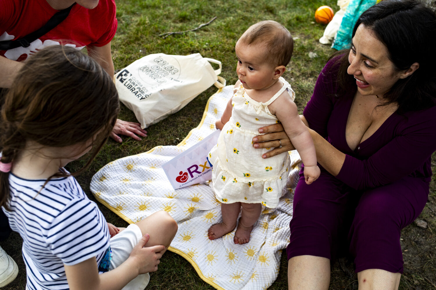 Caroline Doennez smiles as she holds up her nine-month-old daughter, Violet, during the Flint Rx Ki...