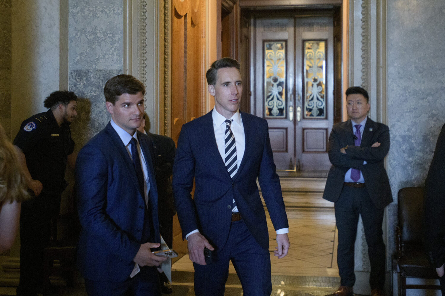 Sen. Josh Hawley, R-Mo., walks from the Senate chamber as Senate Republicans vote on President Dona...