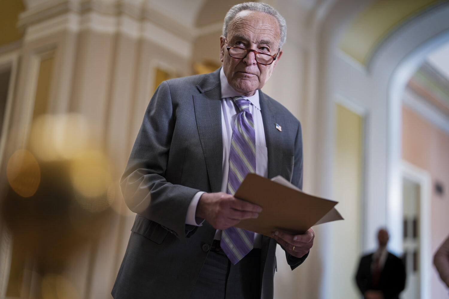 Senate Minority Leader Chuck Schumer, D-N.Y., looks over notes as Senate Republicans work to cancel...