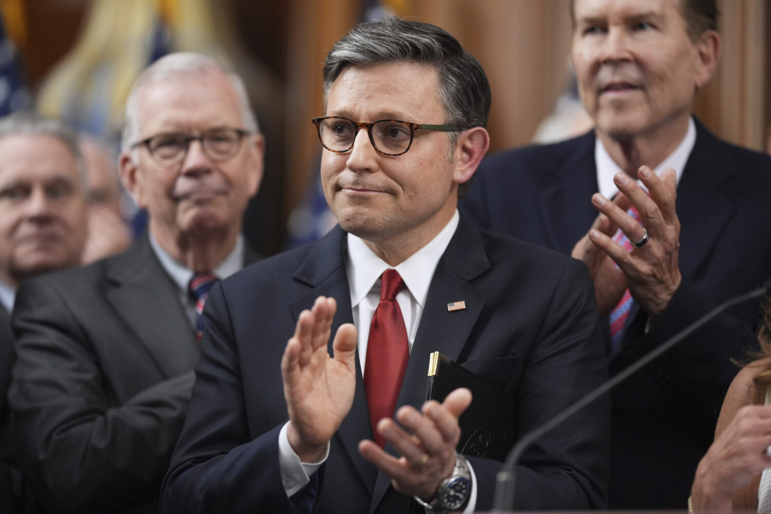 Speaker of the House Mike Johnson, R-La., is seen with other Republican House members after the pas...