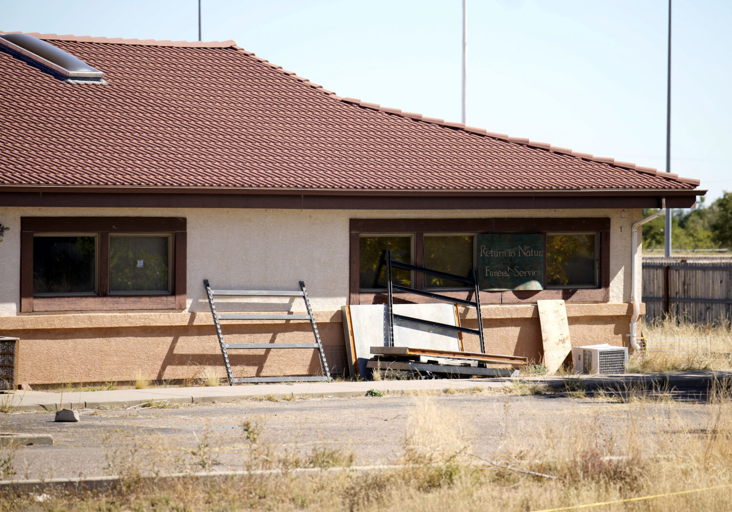 FILE - A sign covers the broken back window of the Return to Nature Funeral Home in Penrose, Colo.,...