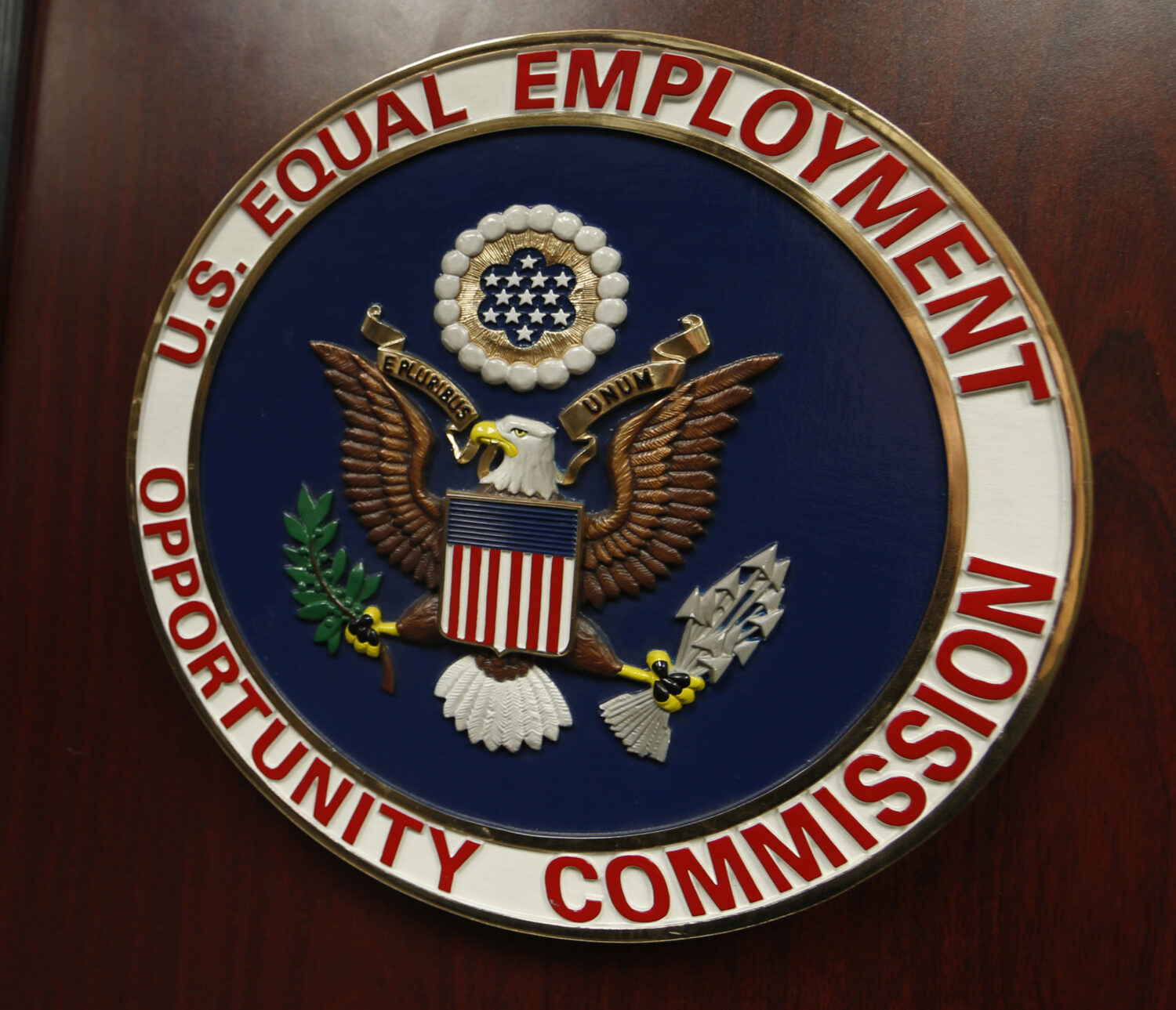 FILE - The emblem of the U.S. Equal Employment Opportunity Commission (EEOC) is shown on a podium i...