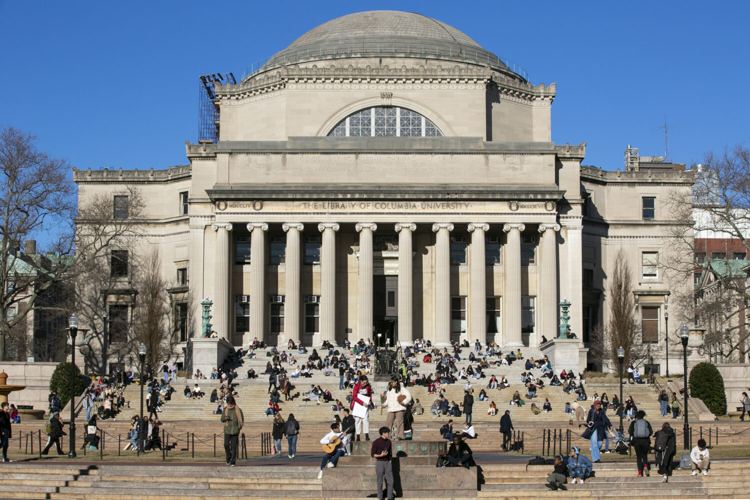 FILE - Students sit on the front steps of Low Memorial Library on the Columbia University campus in...