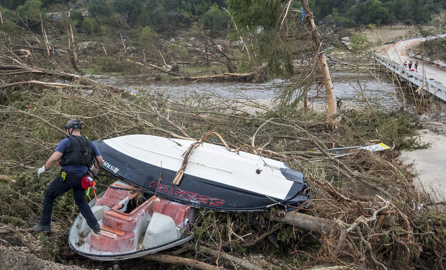 First responders from College Station Fire Department search along the banks of the Guadalupe River...