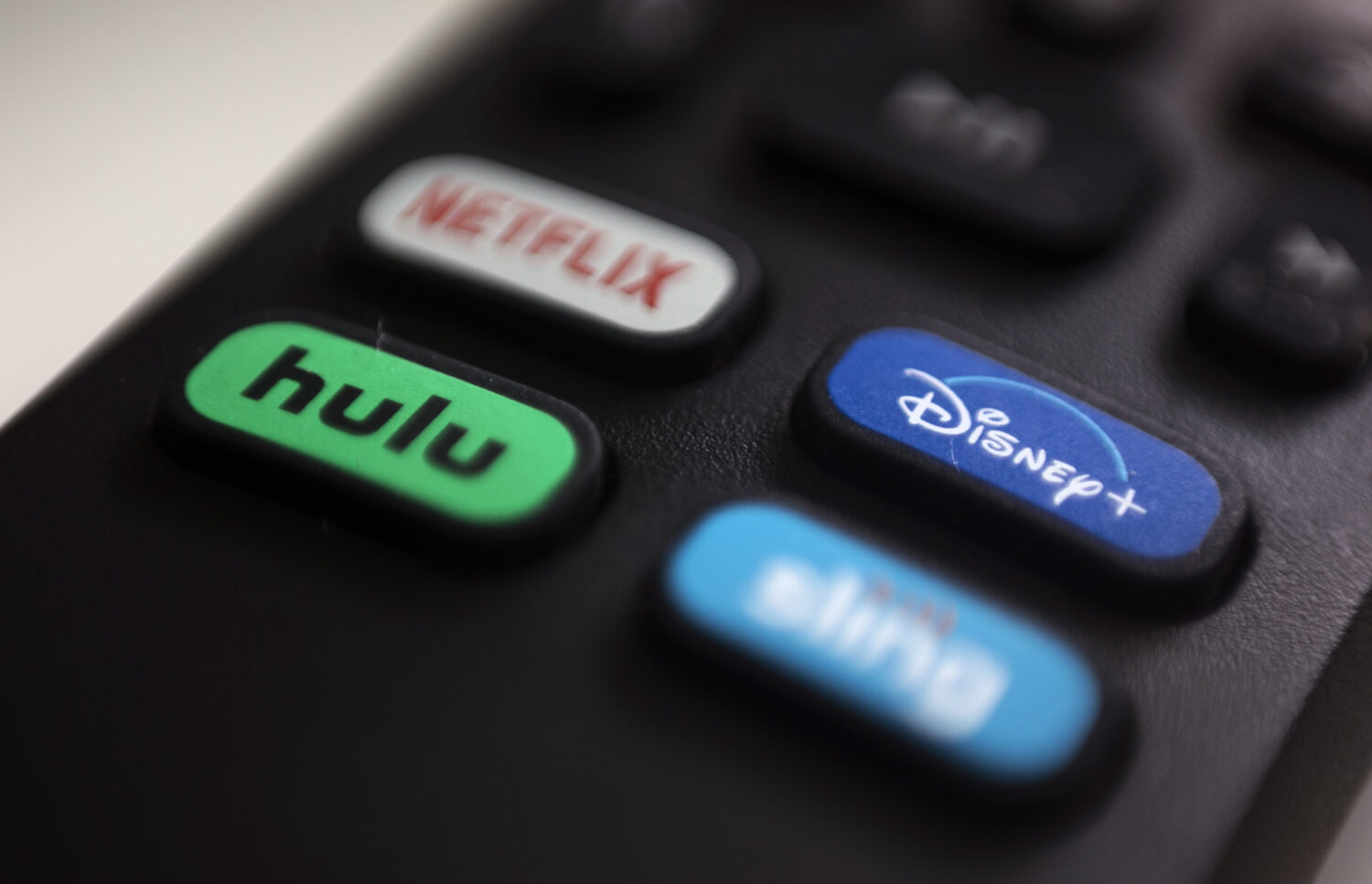 FILE - The logos for streaming services Netflix, Hulu, Disney Plus and Sling TV are pictured on a r...