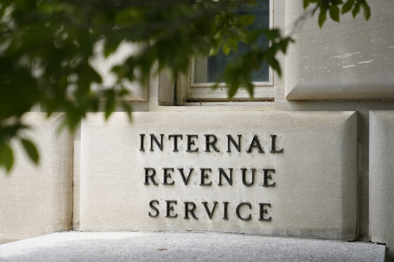 FILE - A sign outside the Internal Revenue Service building is photographed May 4, 2021, in Washing...